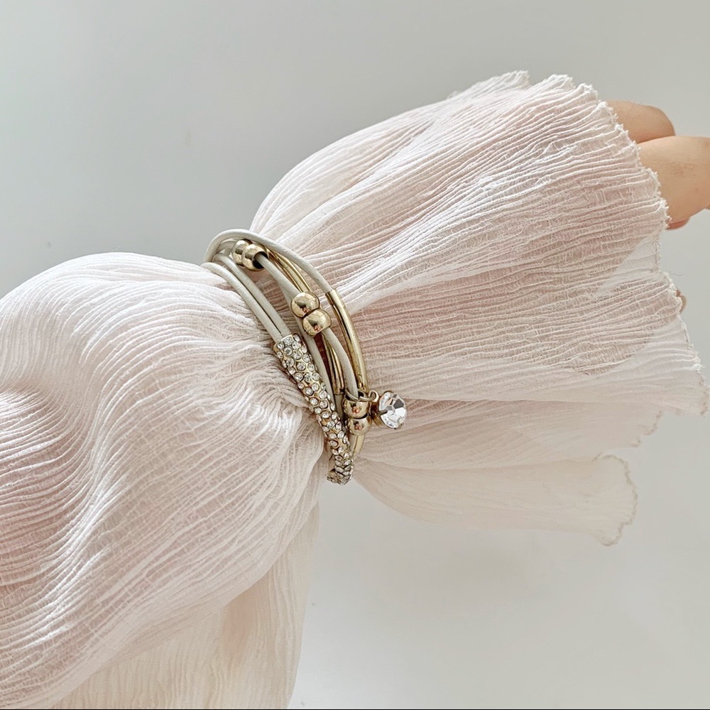 cream faux leather strap, gold hardware bracelet